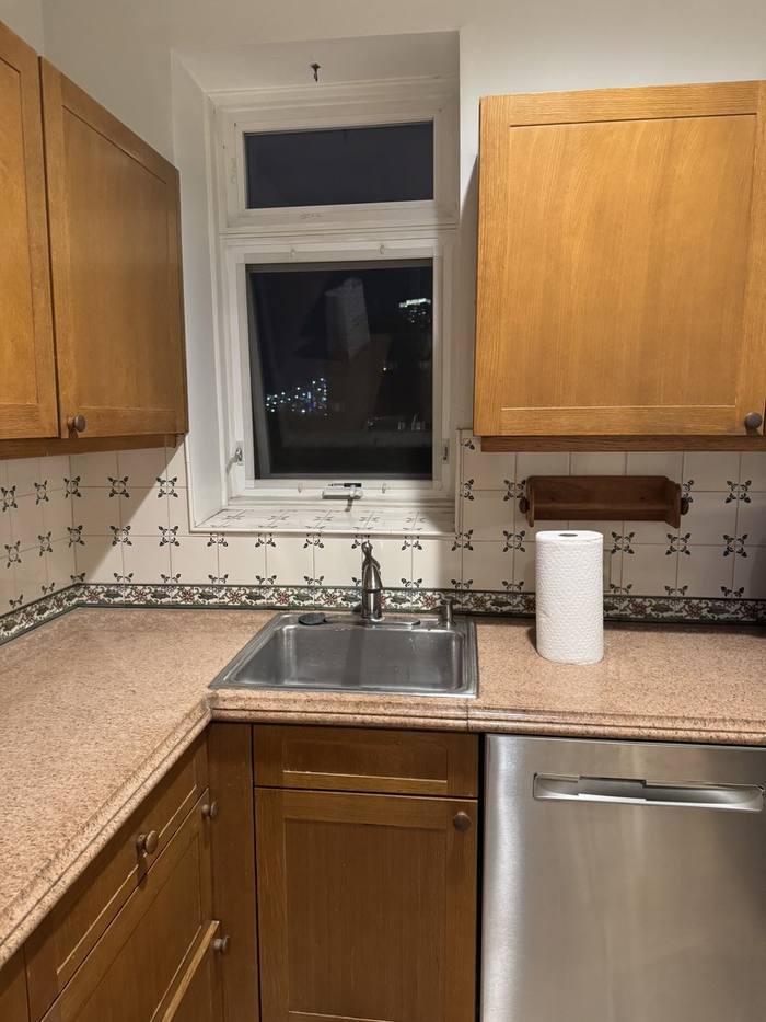 The kitchen before: oak cabinets, laminate counters and tiled backsplash