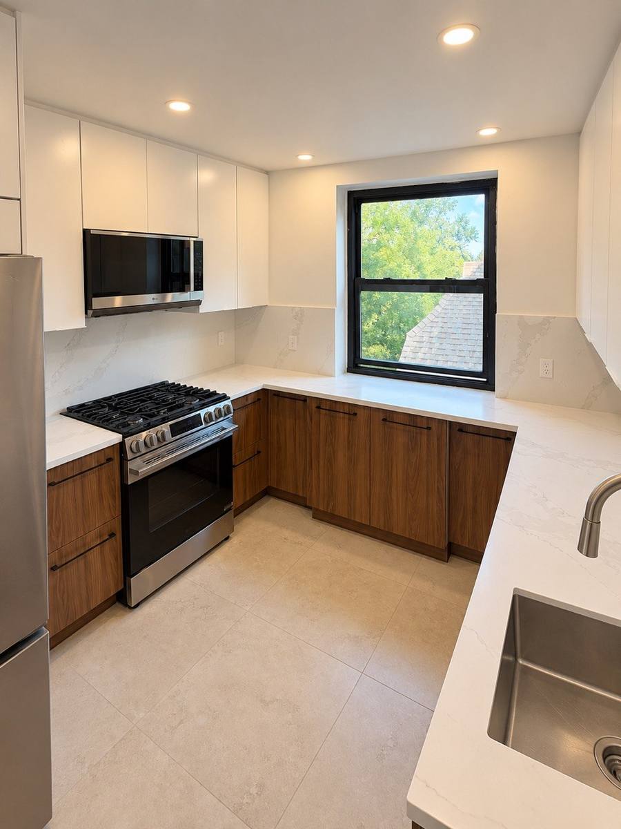 U-shaped Brooklyn kitchen with walnut lower cabinets and white uppers