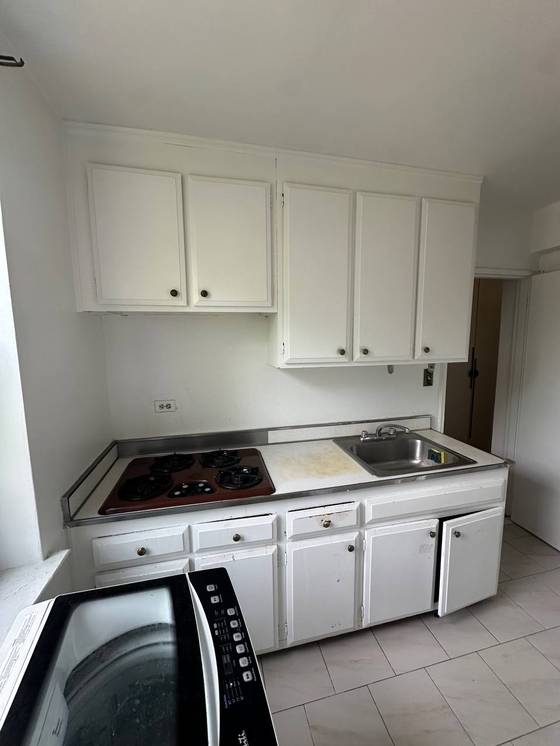 Before: Old cooktop and sink run